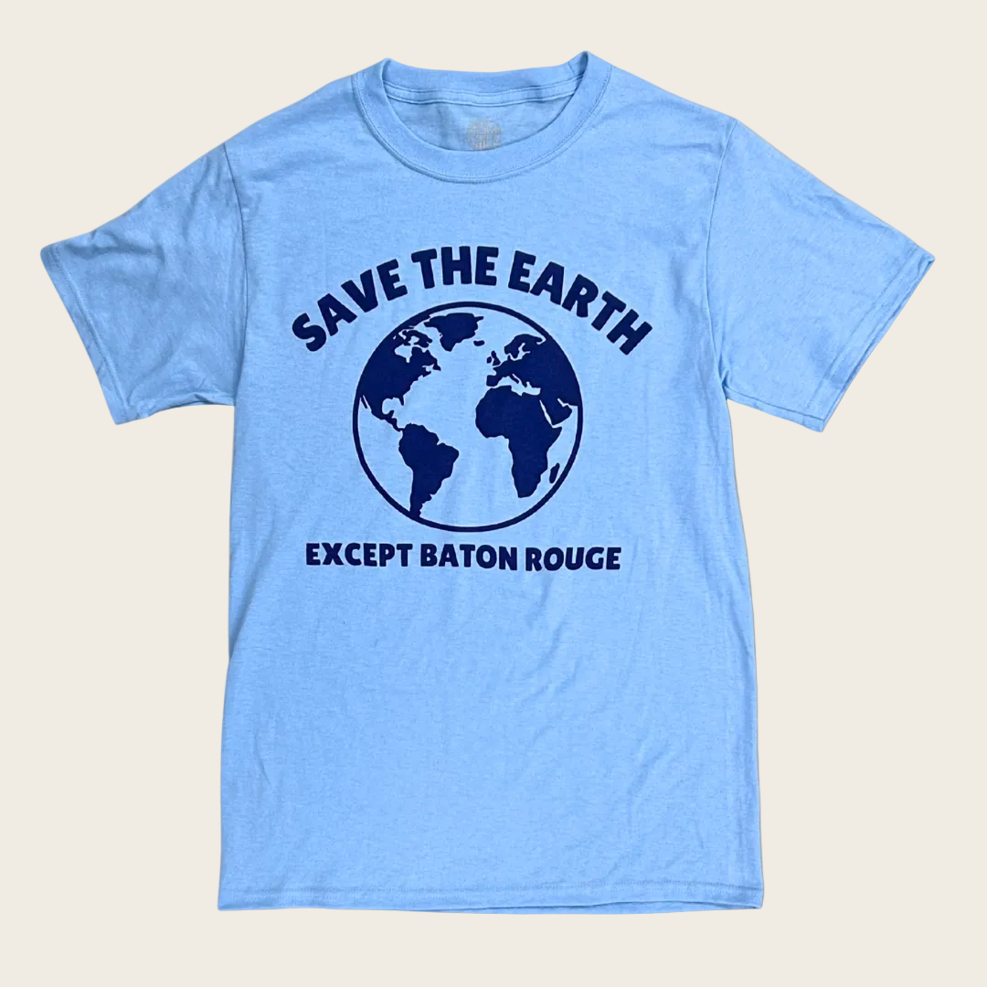 A light blue short-sleeve t-shirt with a dark blue graphic on the front showing a globe and the text 'SAVE THE EARTH' and 'EXCEPT BATON ROUGE'.