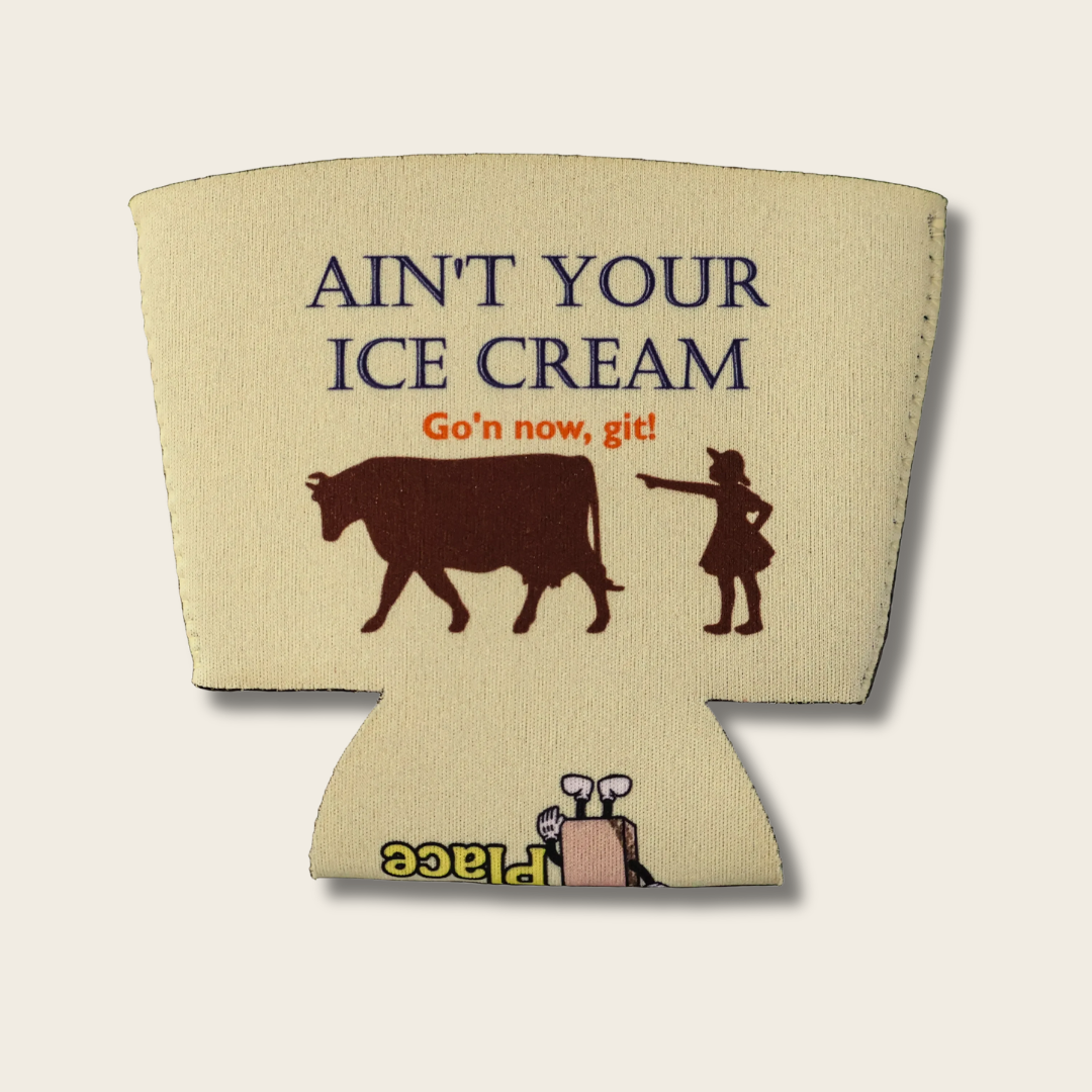 A yellow-beige fabric ice cream cooler sleeve with a printed graphic that reads 'AIN'T YOUR ICE CREAM Go'n now, git!' above a brown cow and a small girl pointing. 