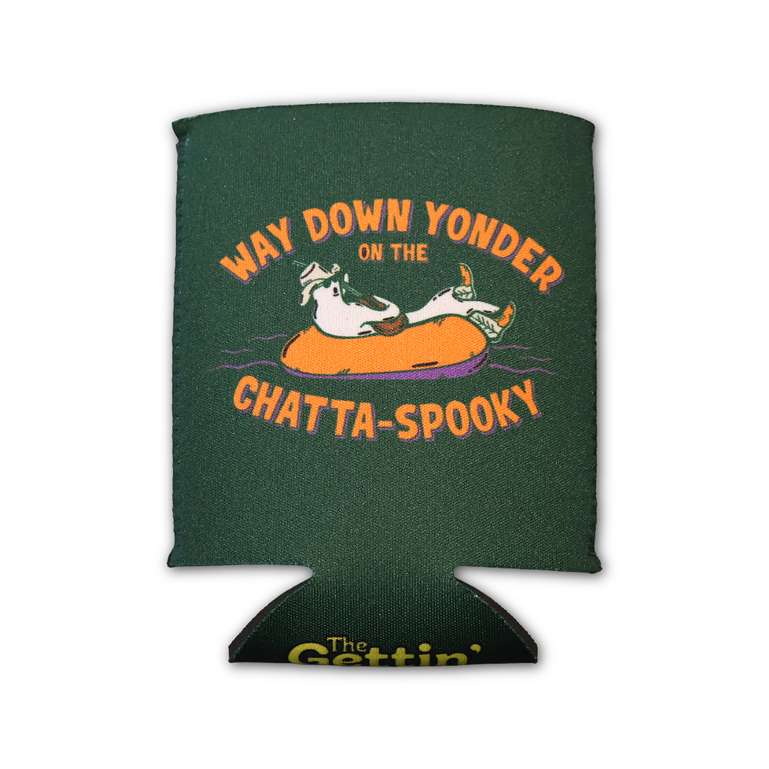 A dark forest green can cooler featuring a cartoon graphic of a ghost wearing a hat and sunglasses, floating on an orange inner tube. The text reads 'WAY DOWN YONDER ON THE CHATTA-SPOOKY' in orange.