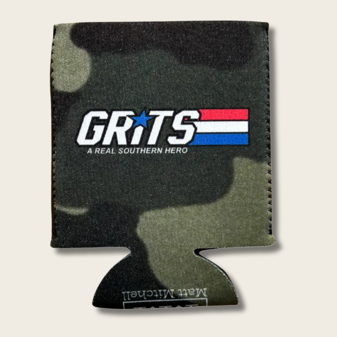 A camouflage can cooler sleeve featuring a green, black, and brown camo pattern with a white 'GRITS' logo and a red, white, and blue flag graphic on the front.