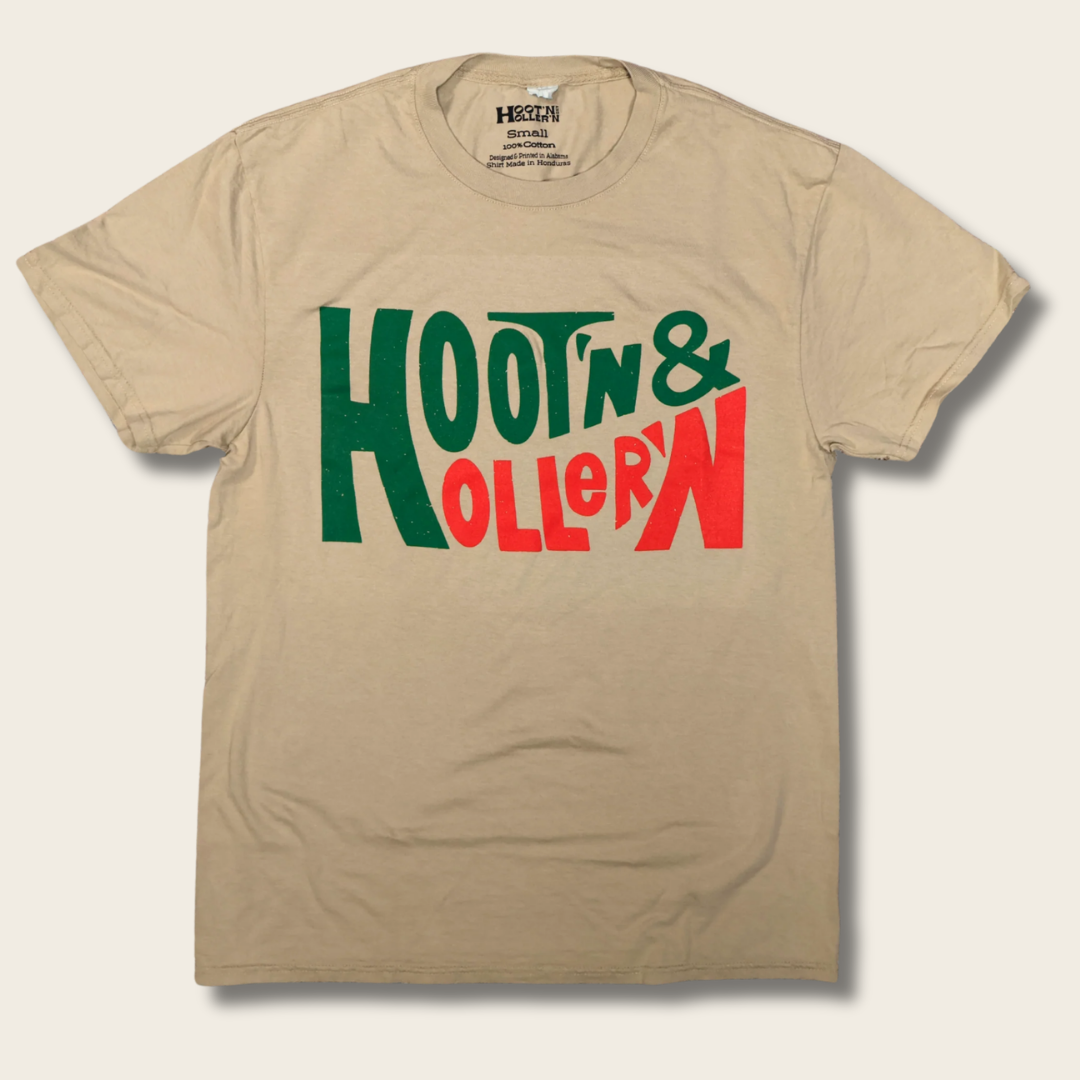 A beige crewneck t-shirt featuring a graphic print on the front that reads 'HOOTIN' & HOLLER' in stylized green and red lettering, displayed against a light beige background.