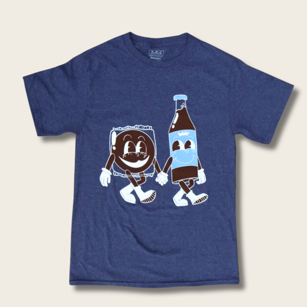 A heather navy blue short-sleeve t-shirt featuring a cartoon graphic of a smiling marshmallow sandwich character and a brown soda bottle character holding hands, displayed flat against a light beige background.